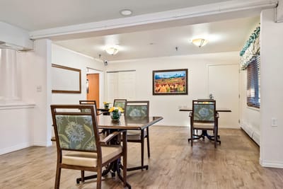 Common area with dining tables and artwork