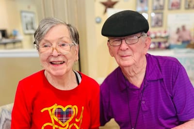 Two smiling residents in the common area