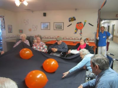 Residents participating in a group activity with balloons