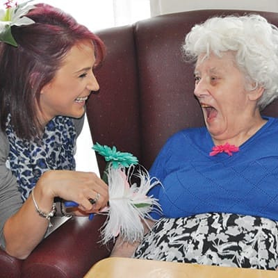 Staff engaging with a resident in an activity
