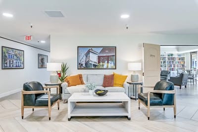 Common area with seating and bookshelves in the background