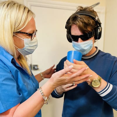 Staff assisting a resident in a care setting