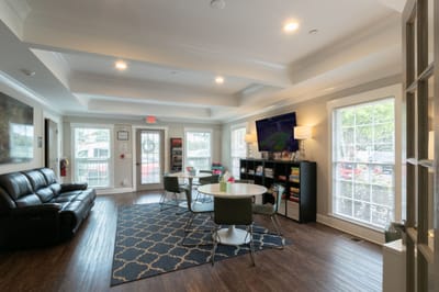 Bright common area with seating and tables
