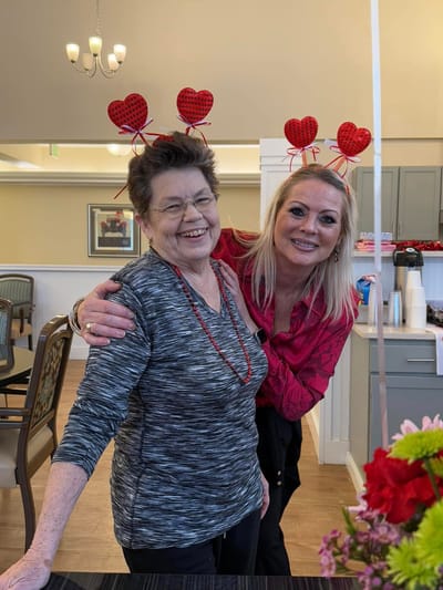 Residents and staff celebrating with heart headbands