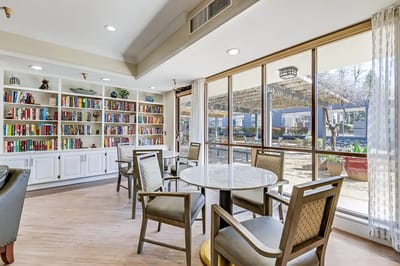 Bright common area with bookshelves and outdoor views