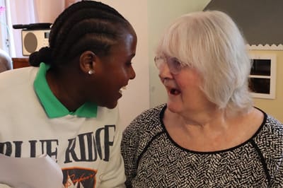 Care staff engaging with a resident in an indoor setting
