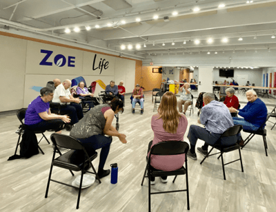 Residents participating in an activity in a spacious common area