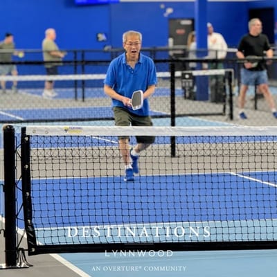 Residents playing pickleball in a spacious activity area