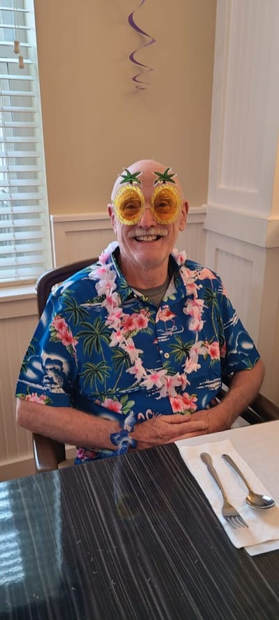 Resident celebrating with festive glasses and decorations