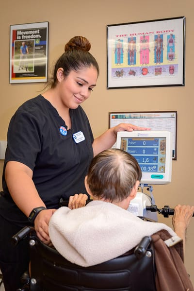 Staff assisting a resident during a therapy session