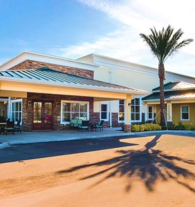 Exterior view of Certus at Waterford Lakes with palm trees