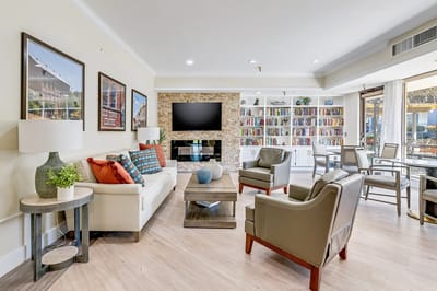 Bright common area with comfortable seating and bookshelves