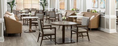 Bright and modern common area with seating and tables
