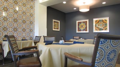 Bright dining room with patterned decor and tables