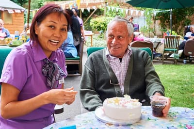 Staff member celebrating a resident's birthday outdoors