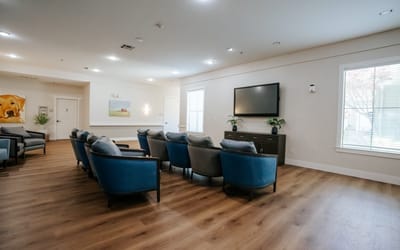 Bright common area with seating and a television