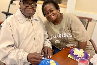 Two residents enjoying dessert at a table