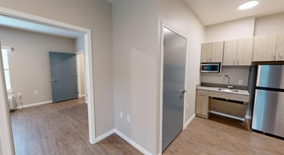 A view of a modern resident room with kitchenette