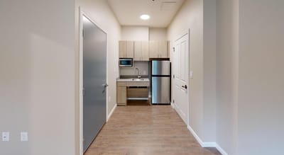 Interior view of a private resident room with kitchenette
