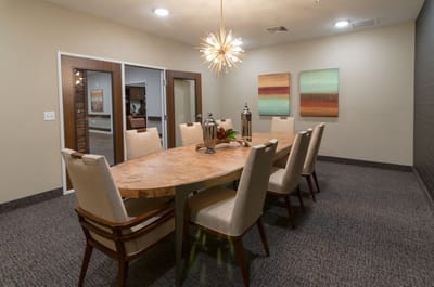 A well-furnished dining room with a large table and decorative items.