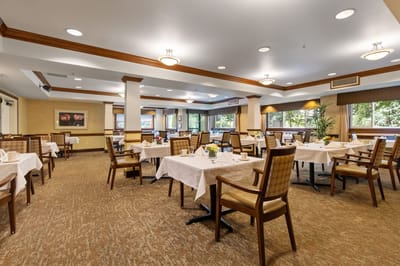 Bright dining room setup with tables and chairs