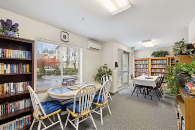 Cozy common area with bookshelves and dining table