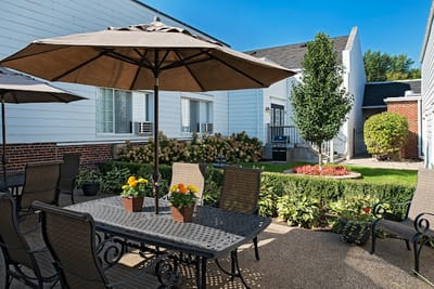 Outdoor seating area with tables and umbrellas