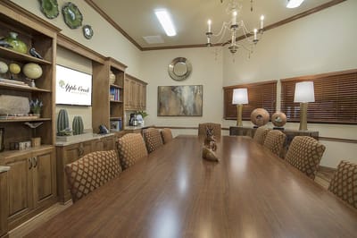 A well-lit meeting room with a large wooden table