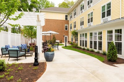 Pathway through landscaped outdoor area with seating