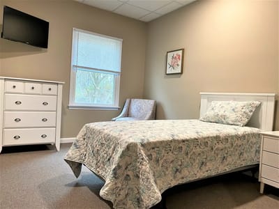 Well-furnished private resident room with bed and TV