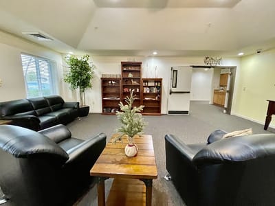 Common area with seating and decor in a senior living facility
