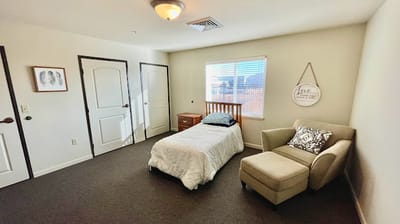 Private resident room with a bed and a chair