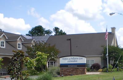 Exterior view of the facility with signage and landscaping