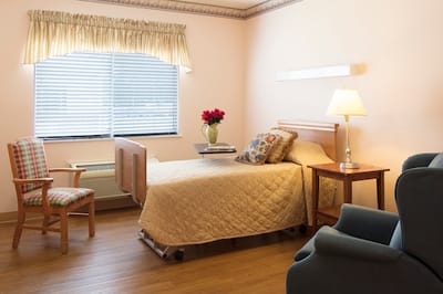 A well-furnished private resident room with flowers