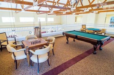 Bright common area with chess and pool tables
