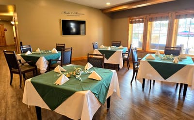 Bright dining room set with green tablecloths and napkins