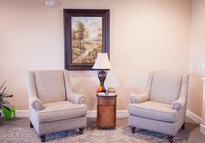 Cozy sitting area with two armchairs and a lamp