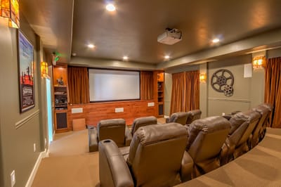 A cozy theater room with leather seating.