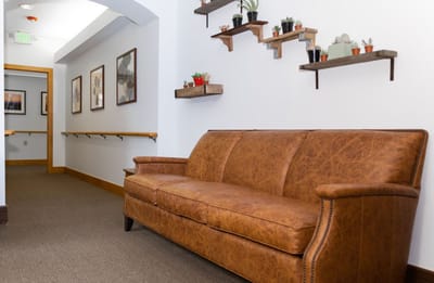 A cozy seating area in a hallway with plants