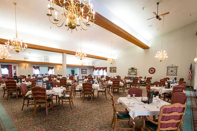 Dining room with tables and chairs set for meals