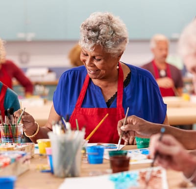 Residents painting in an activity room
