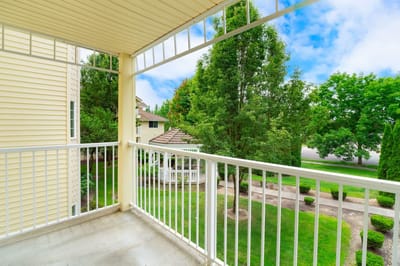 View from a balcony overlooking landscaped grounds