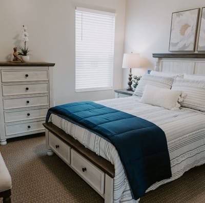 Cozy private resident room with a bed and dresser
