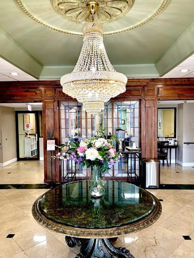Elegant lobby interior with floral arrangements and chandelier