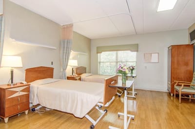 Bright interior of a nursing home room with two beds