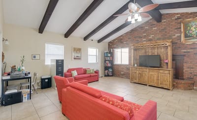 Bright interior lounge area with seating and bookshelf