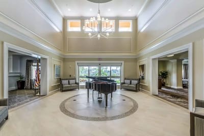 Spacious common area with a grand piano and seating