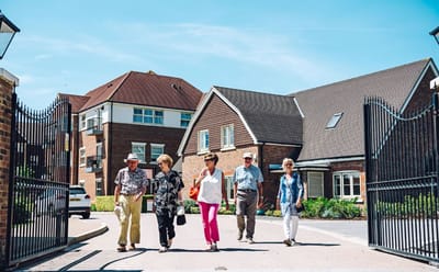 Residents walking through the entrance of Durrants Village