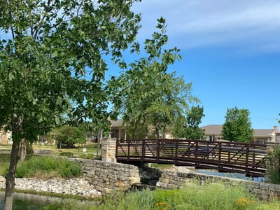 Beautiful outdoor space with a wooden bridge and landscaped area