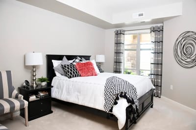 Brightly decorated resident room with a bed and seating
